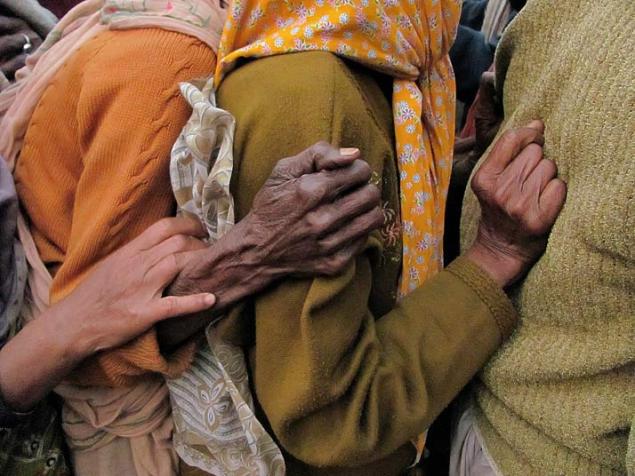 January 18, 2012 This picture was taken from Gangasagar Transit Camp, Kolkata. Each year thousands of sadhus and other people come here for Gangasar Yatra. Basically, Gangasagar Yatra is a spiritual festival in India. In this picture they are standing for food. These three hands are signifying that struggle is everywhere.