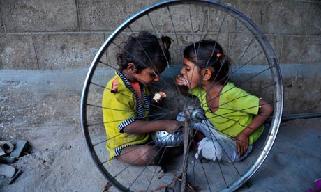 Indian children eat food on the roadside in Hyderabad, 2011. Will extreme poverty have disappeared in 17 years' time? Photograph: Noah Seelam/AFP/Getty Images (SOURCE: guardian.co.uk)